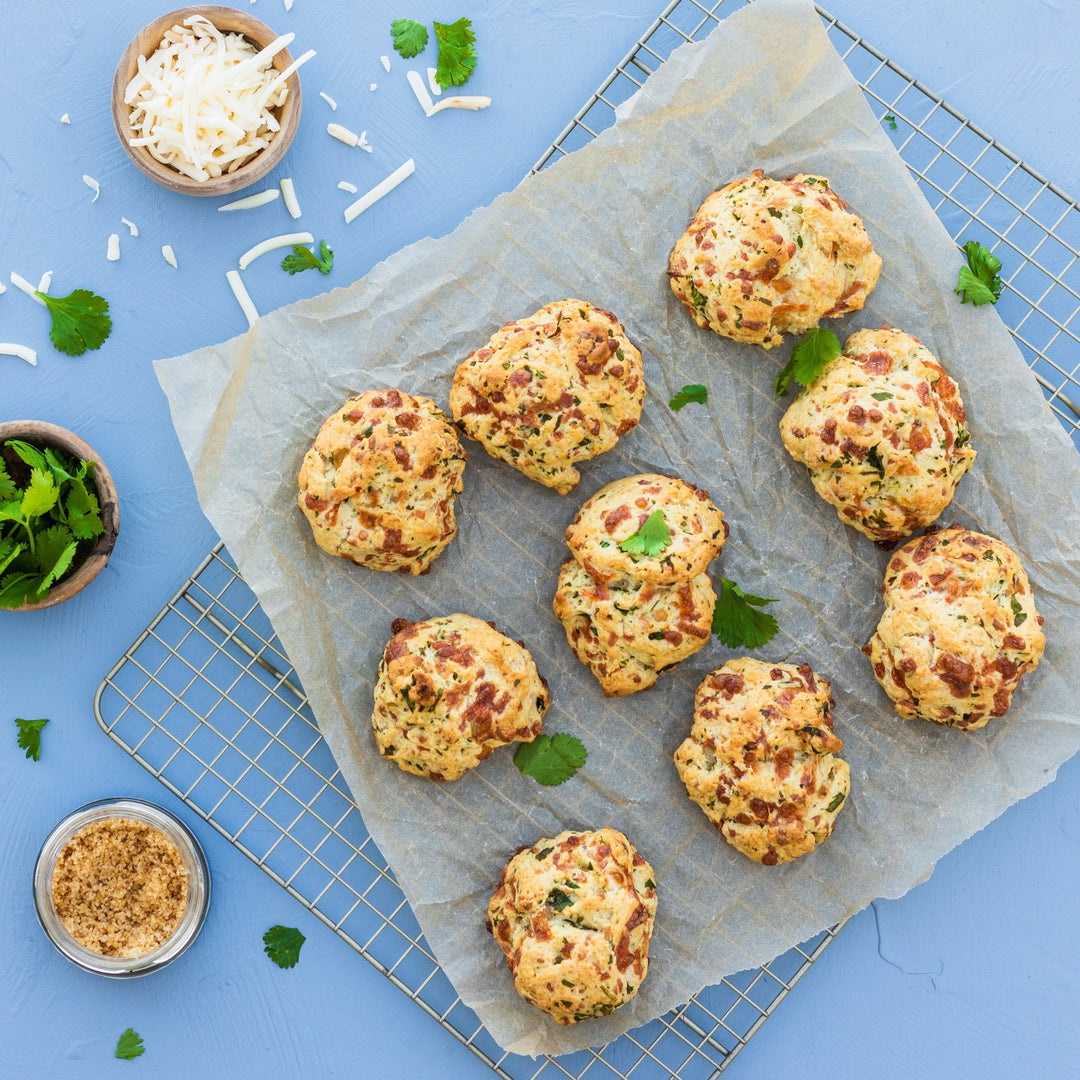 Pasolivo Cilantro Lime Biscuits Recipe on a cooling rack next to a bowl of cheese 