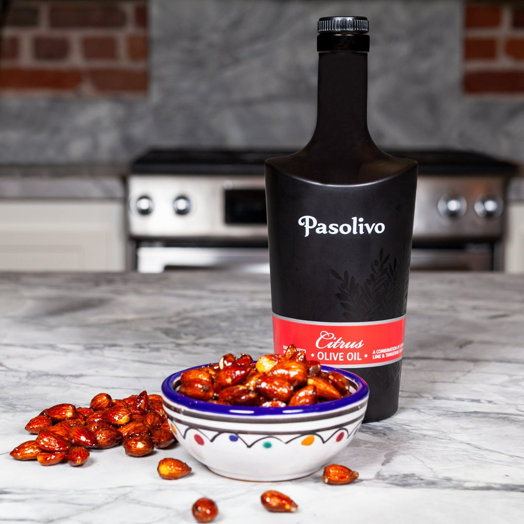 Pasolivo Citrus Delight Almonds Recipe on a countertop next to Pasolivo Citrus Olive Oil